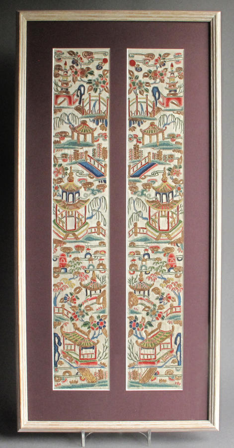 A framed finely worked pair of Chinese silk sleeve bands, C19th