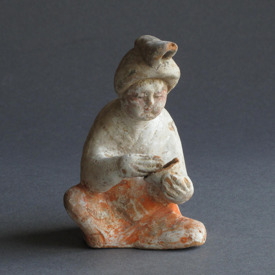 A charming small Tang Dynasty figure of a seated woman
