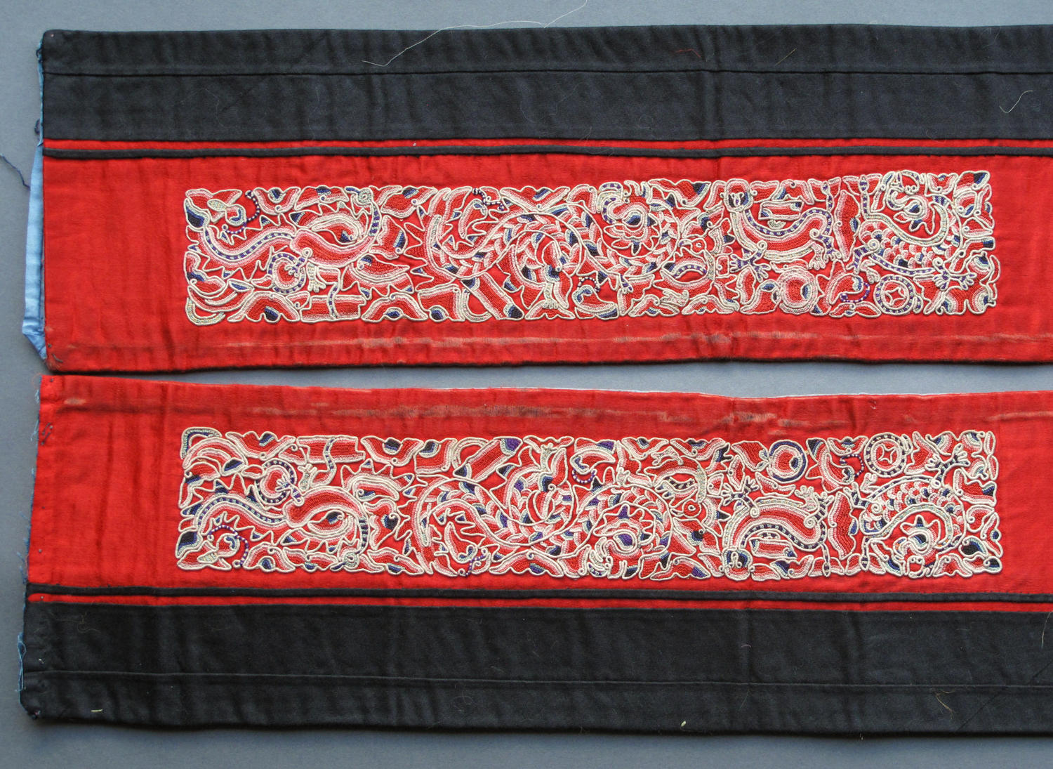 A pair of finely-embroidered Chinese sleeve bands cut from a robe, lat