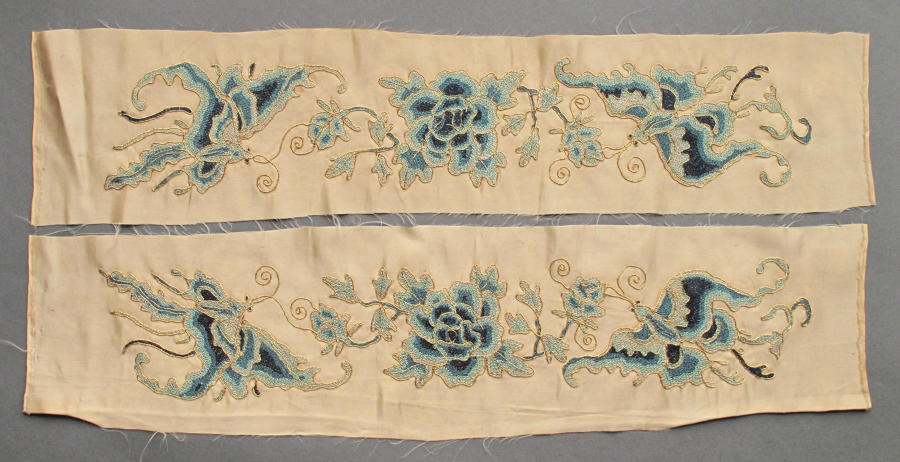A pair of C19th Chinese silk sleeve bands in cream and blue
