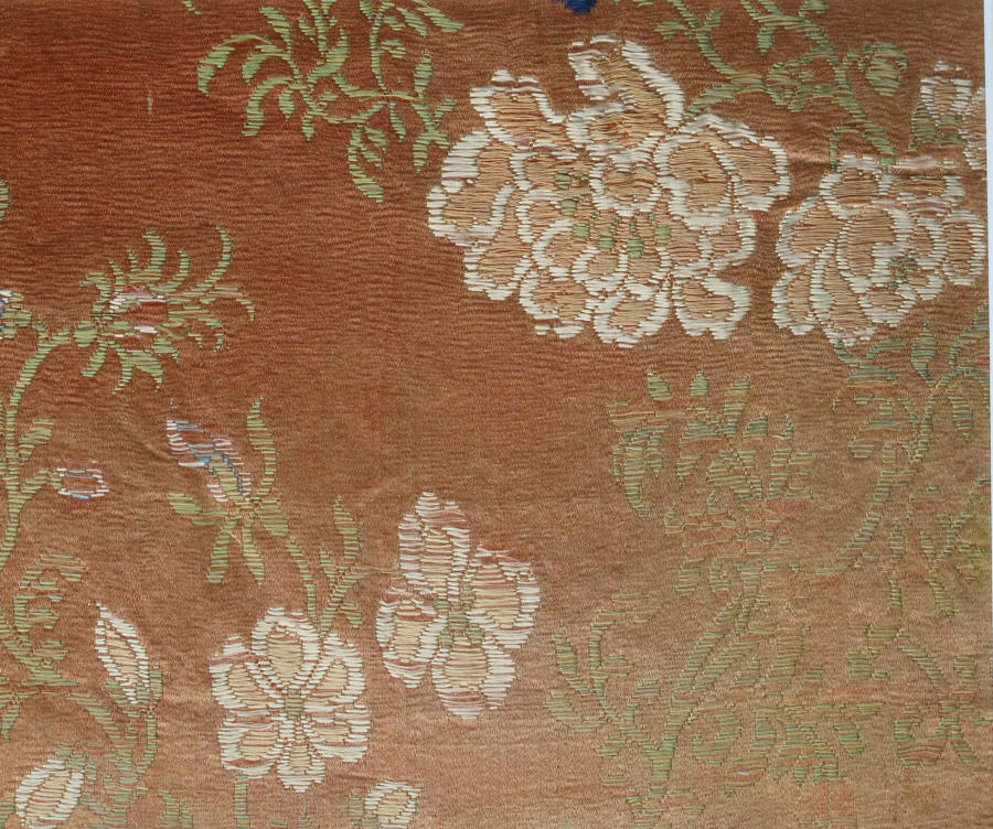 A mounted early C18th Chinese woven silk panel with peony flowers