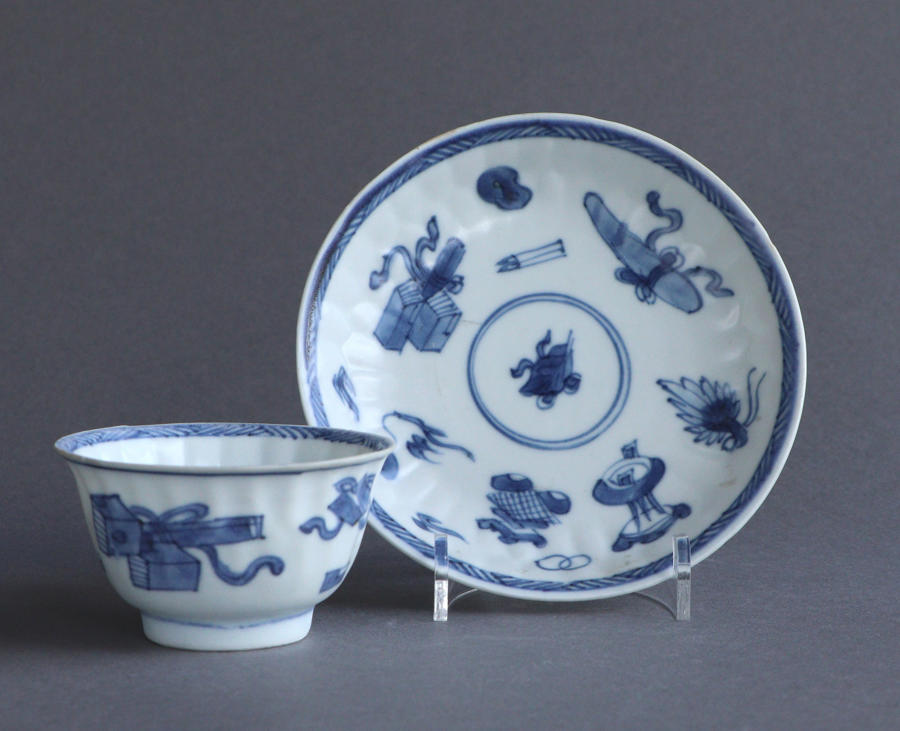 A Chinese 'Blue Chrysanthemum' wreck moulded tea bowl & saucer Kangxi
