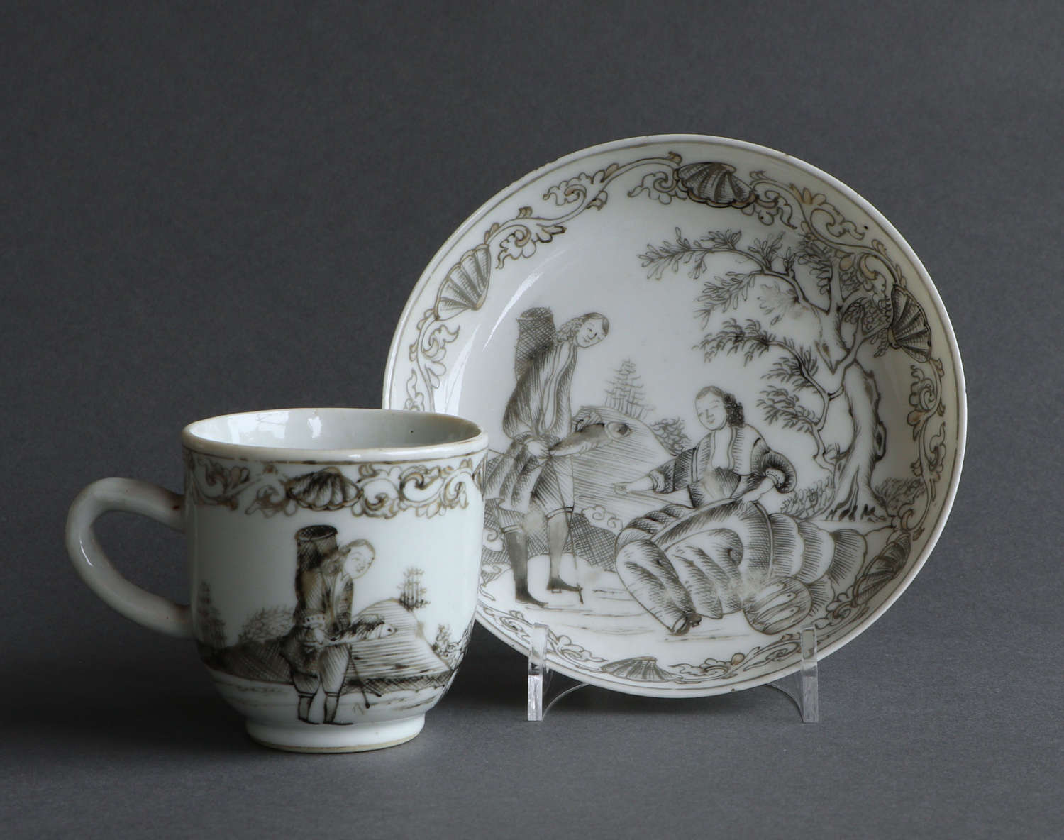 A Chinese export grisaille 'fishing' coffee cup & saucer, Qianlong