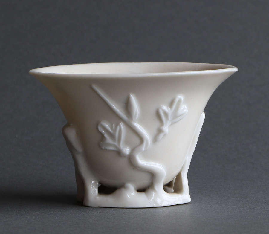A Chinese blanc de Chine libation cup of rhinoceros horn form, Kangxi