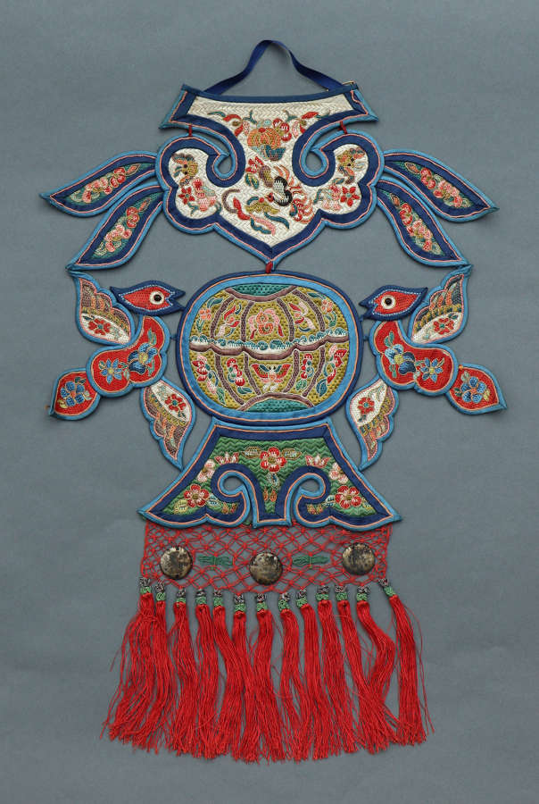 An early C20th Chinese silk neck pendant