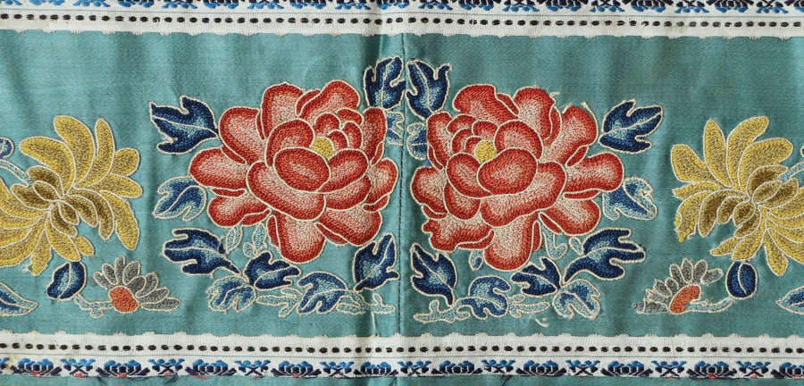 A small C19th Chinese horizontal silk panel of red and pink paeonies