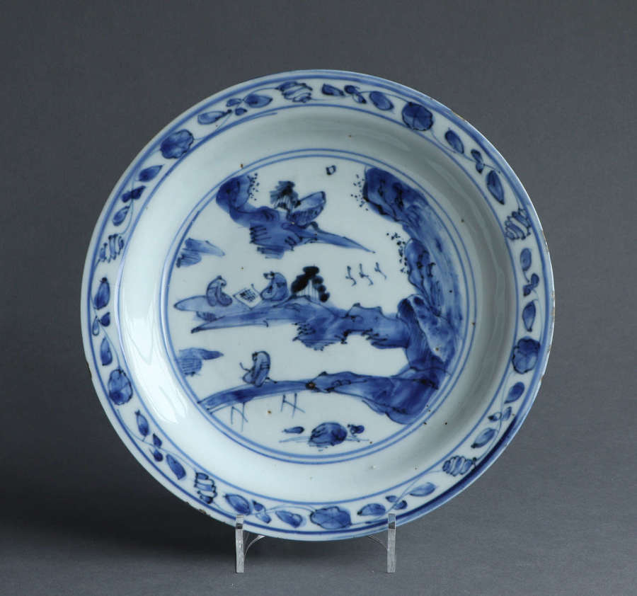 A Chinese late Ming dish with a landscape scene with scholars