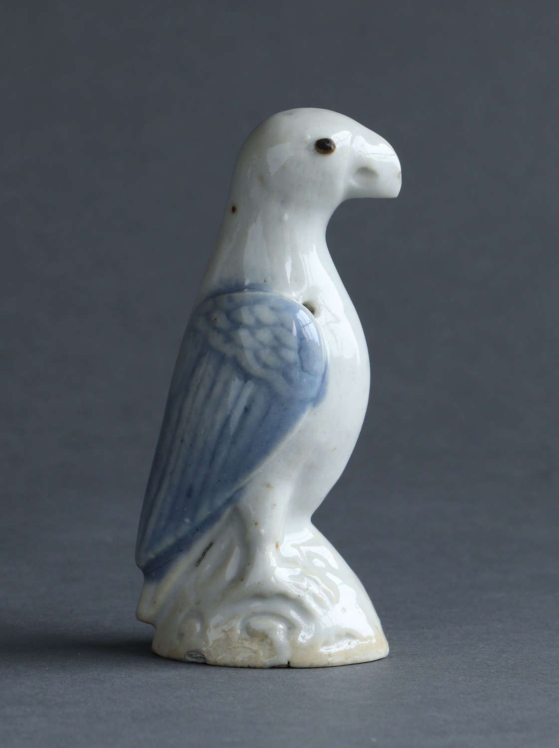 A small Chinese export underglaze blue model of a parrot