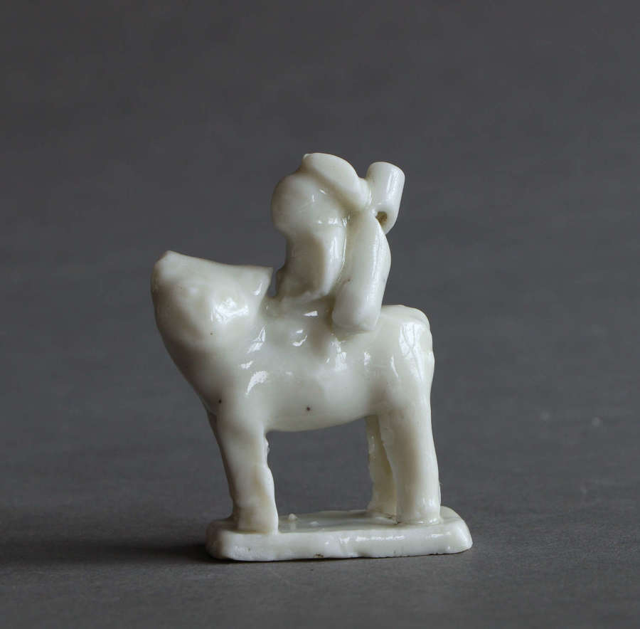 A miniature Chinese blanc de Chine figure of a European riding a tiger